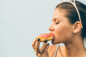 sexy-brunette-lady-eat-sweet-heart-shaped-donut-2HKLRBJ-scaled-300x200 Front Page